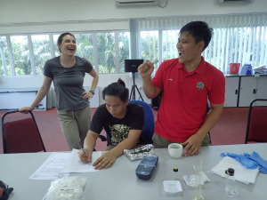 Fikri sings into the pestle while Zadie takes data during nitrate analysis